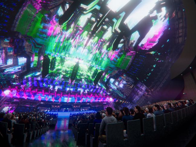 Vor Publikum werden Strukturen beleuchtet in lila und grünen Neonfarben abgebildet