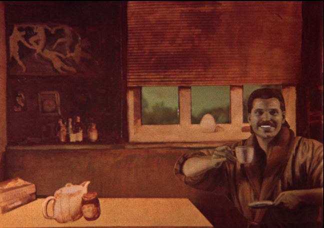 Mann mit Kaffeetasse am Küchentisch