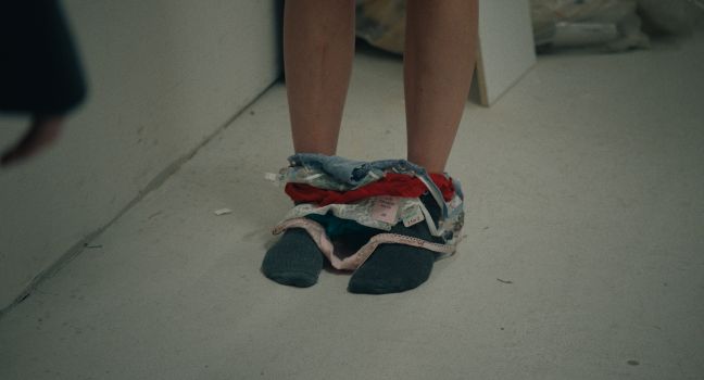 Füße in Umkleidekabine mit Unterhosen mit Etiketten