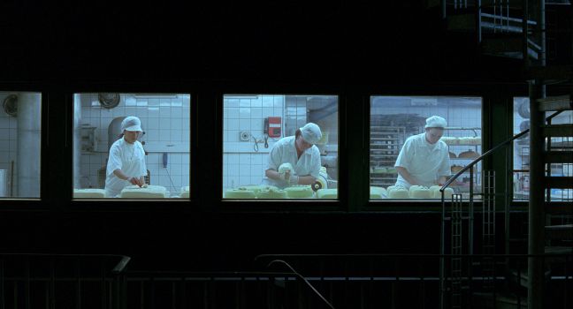 Drei Frauen bereiten nachts Torten vor, jede vor einem Fenster