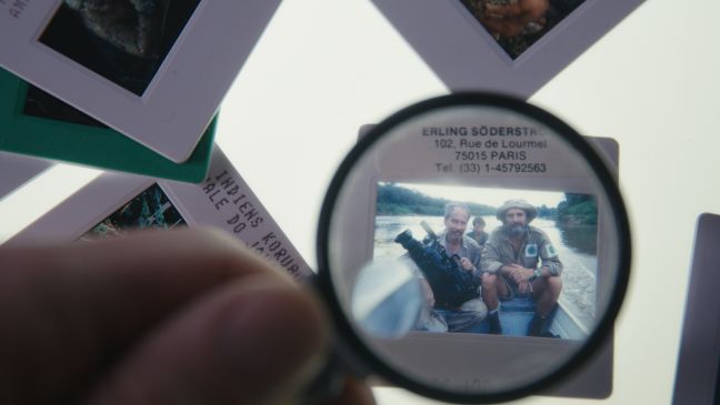 eine Lupe vergrößert ein analoges Foto von Erling Söderström und Sydney Possuelo
