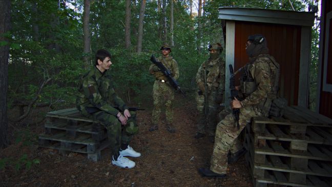 August und drei weitere Männer in Uniform im Wald