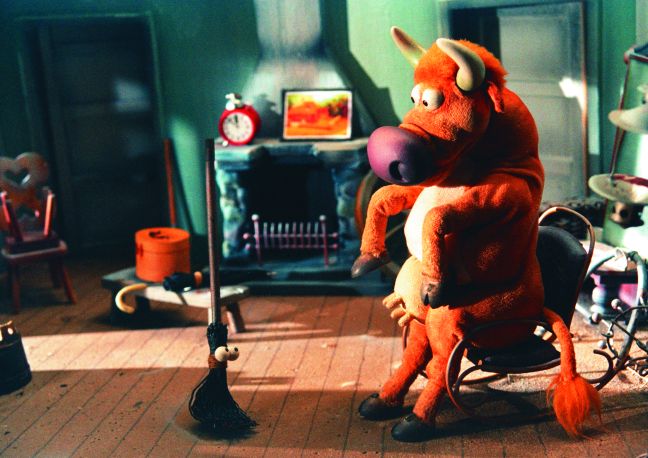 Berta sitzt auf dem Stuhl im Haus und spricht mit dem Besen